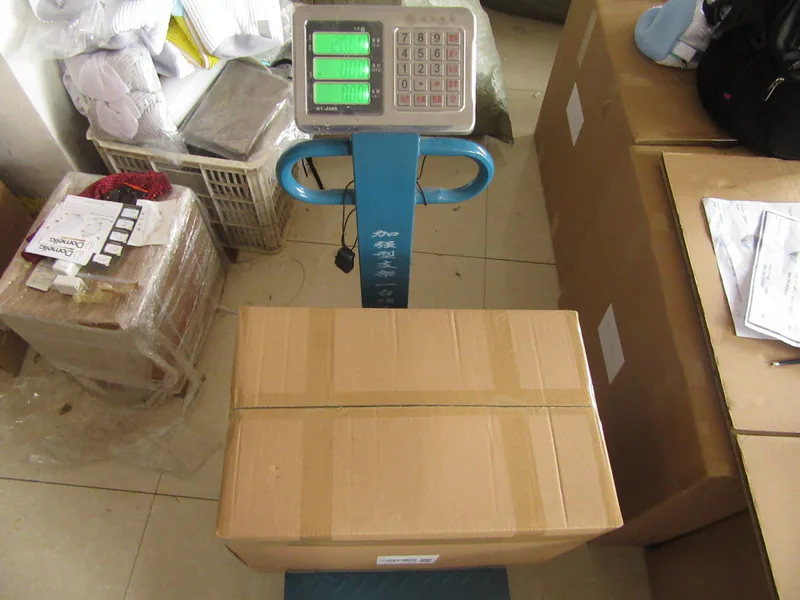 Carton weight being checked as part of an order-specific inspection