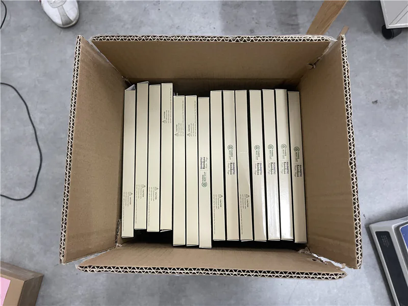 Finished retail boxes arranged inside an export carton for pre-shipment review