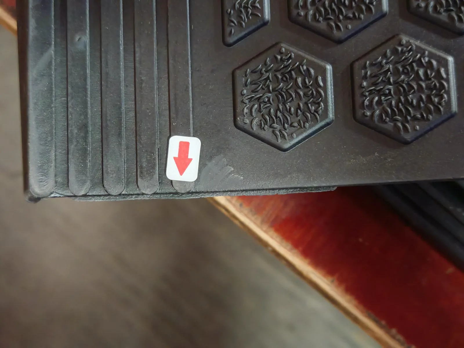 Close-up evidence of a visible product edge issue marked during inspection